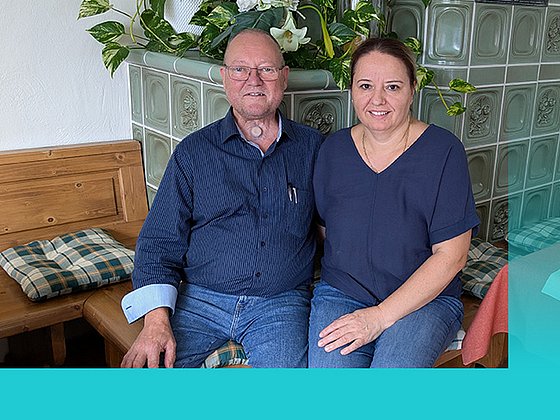 Ehepaar Frohmüller auf der Ofenbank ihres Kamins im Gastraum